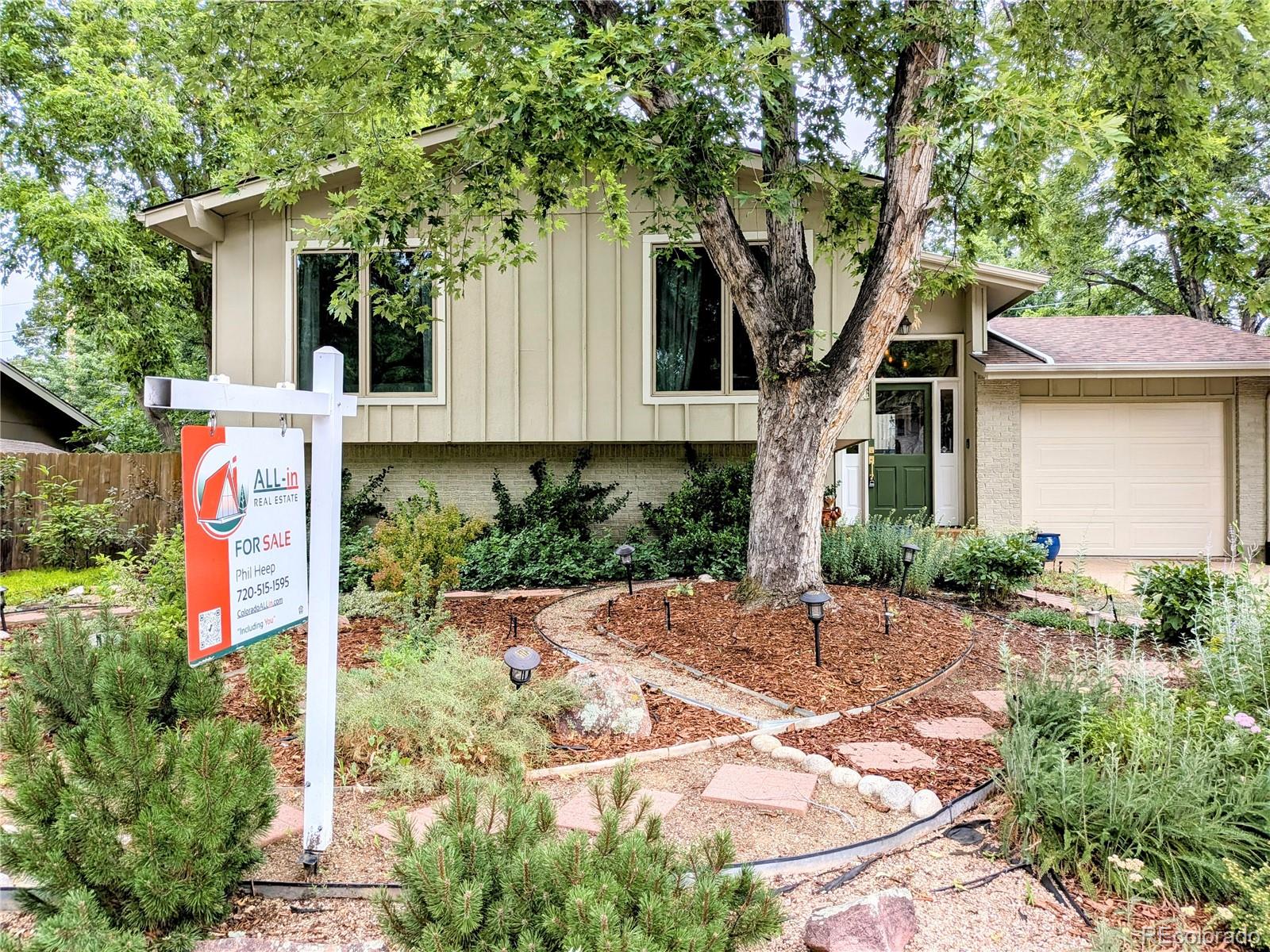 1080 Ithaca Drive Boulder, CO 80305 - Photo 5 of 35 a front view of a house with a yard