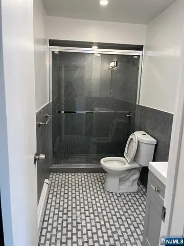 a bathroom with a toilet a a sink and a shower