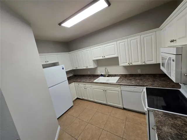 a kitchen with a sink and a refrigerator