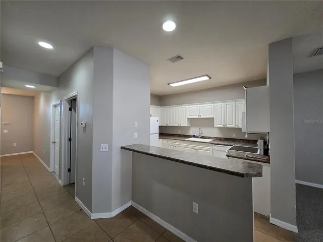 a kitchen with stainless steel appliances granite countertop a sink and cabinets