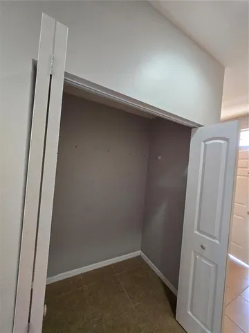 a bathroom with a granite countertop toilet sink and mirror