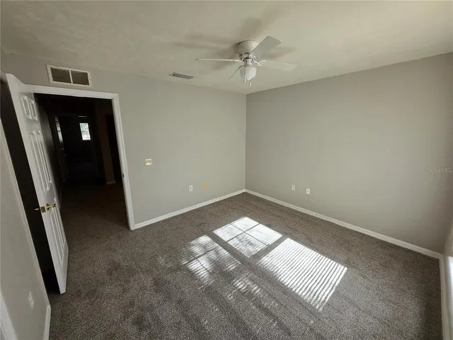 an empty room with windows and closet