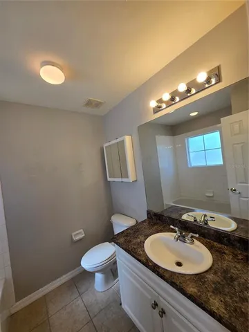 a bathroom with a toilet and bathtub