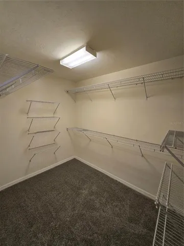 a bathroom with a granite countertop double vanity sink and a mirror