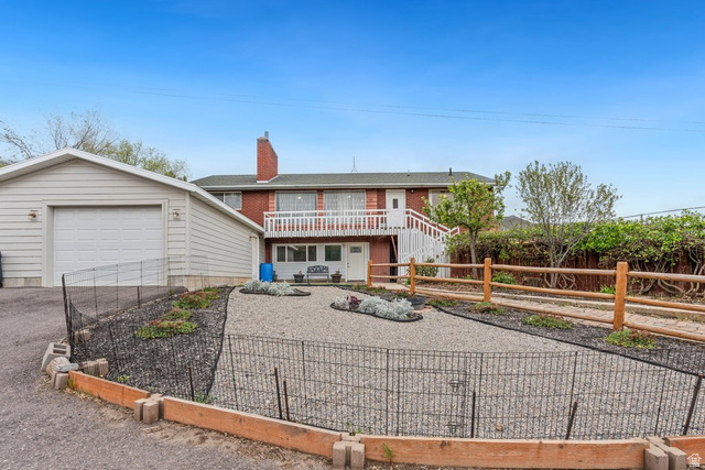 149 West 1600th Street South Mapleton, UT 84664 - Photo 5 of 44 View of front of house featuring a garden, driveway, a chimney, brick siding, and a balcony