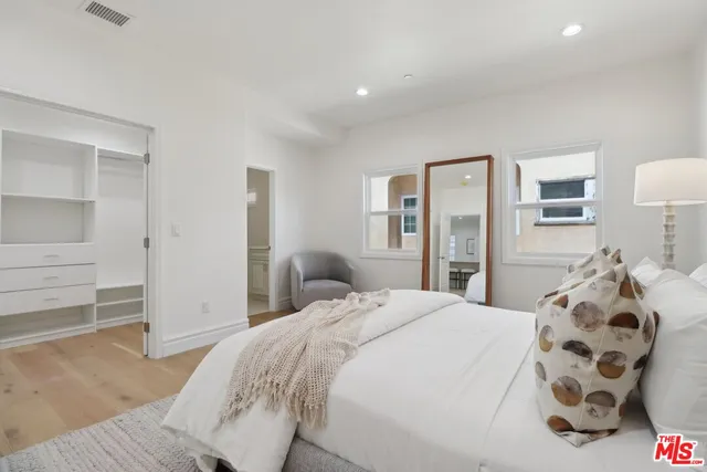 a bedroom with a large bed and a window