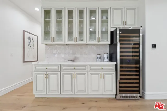 a kitchen with stainless steel appliances white cabinets and a sink