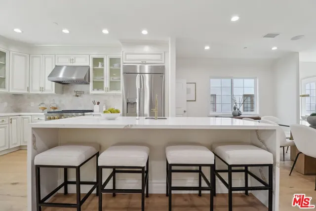 a kitchen with a table chairs sink and cabinets