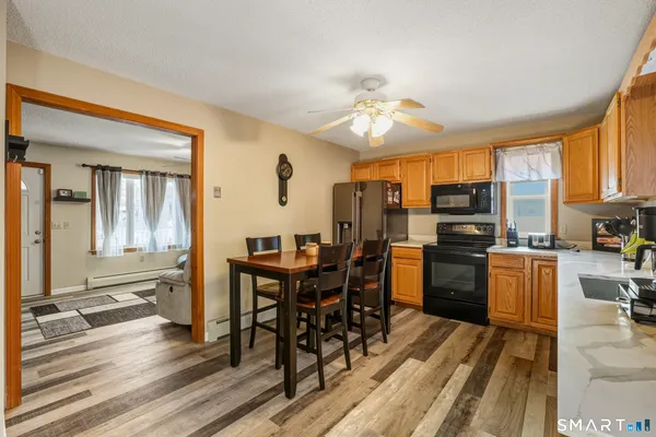 a view of a dining room with furniture window and wooden floor