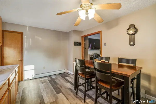 a view of a dining room with furniture and wooden floor