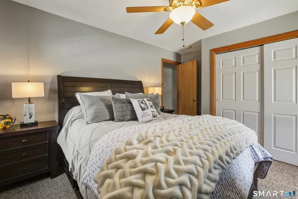 a bedroom with a bed and a chandelier