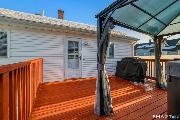 a view of a deck with wooden floor and furniture