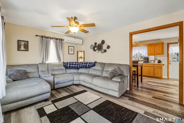 a living room with furniture and a chandelier
