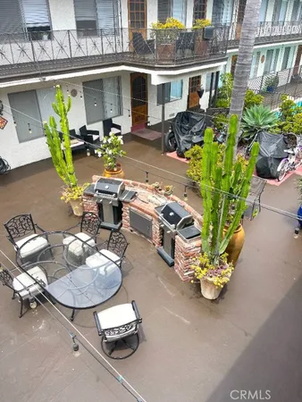 a view of a hallway with potted plants and wooden floor