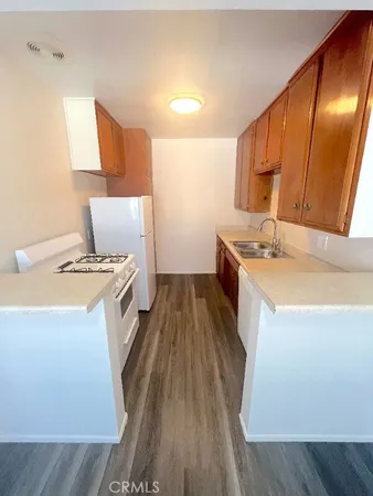 a kitchen with wooden cabinets and a sink