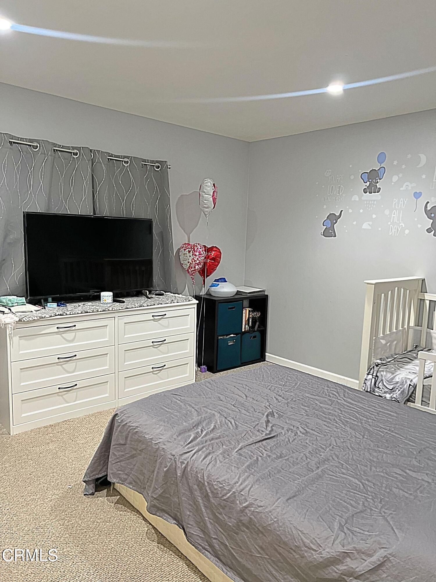 2510 Elderberry Drive, Unit 60 Oxnard, CA 93036 - Photo 13 of 37 a bedroom with a bed and flat screen tv