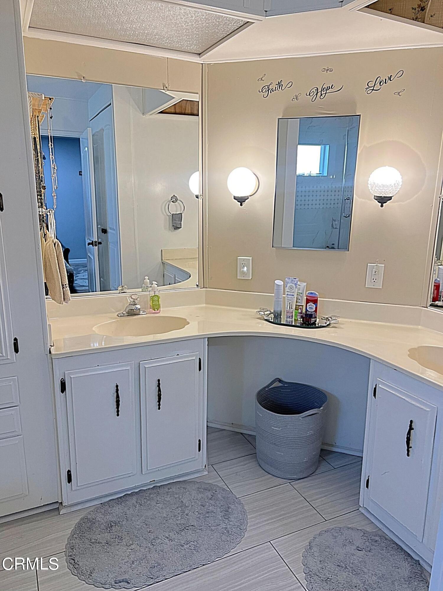 2510 Elderberry Drive, Unit 60 Oxnard, CA 93036 - Photo 19 of 37 a bathroom with a granite countertop sink and a mirror