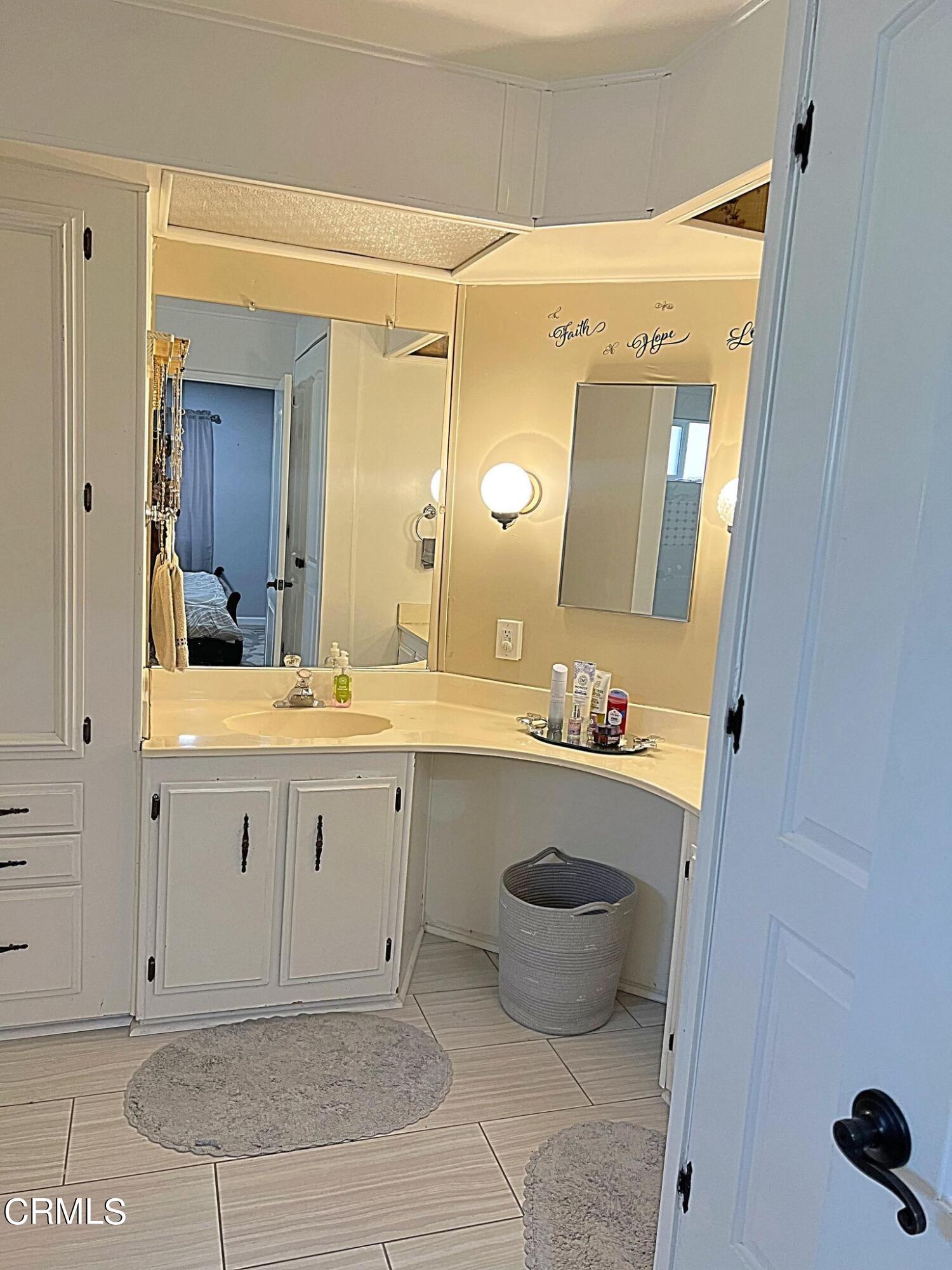 2510 Elderberry Drive, Unit 60 Oxnard, CA 93036 - Photo 20 of 37 a spacious bathroom with a mirror a sink and a mirror