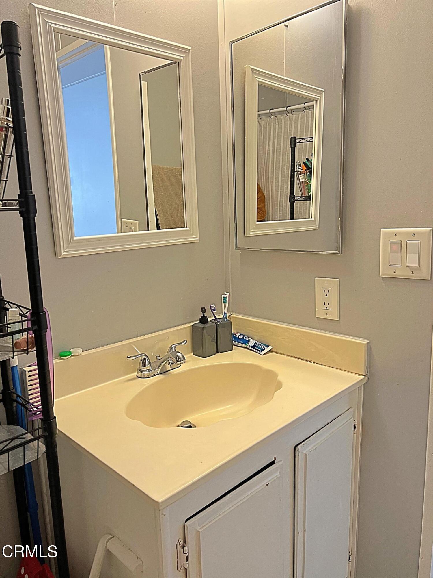 2510 Elderberry Drive, Unit 60 Oxnard, CA 93036 - Photo 24 of 37 a bathroom with a sink and a mirror