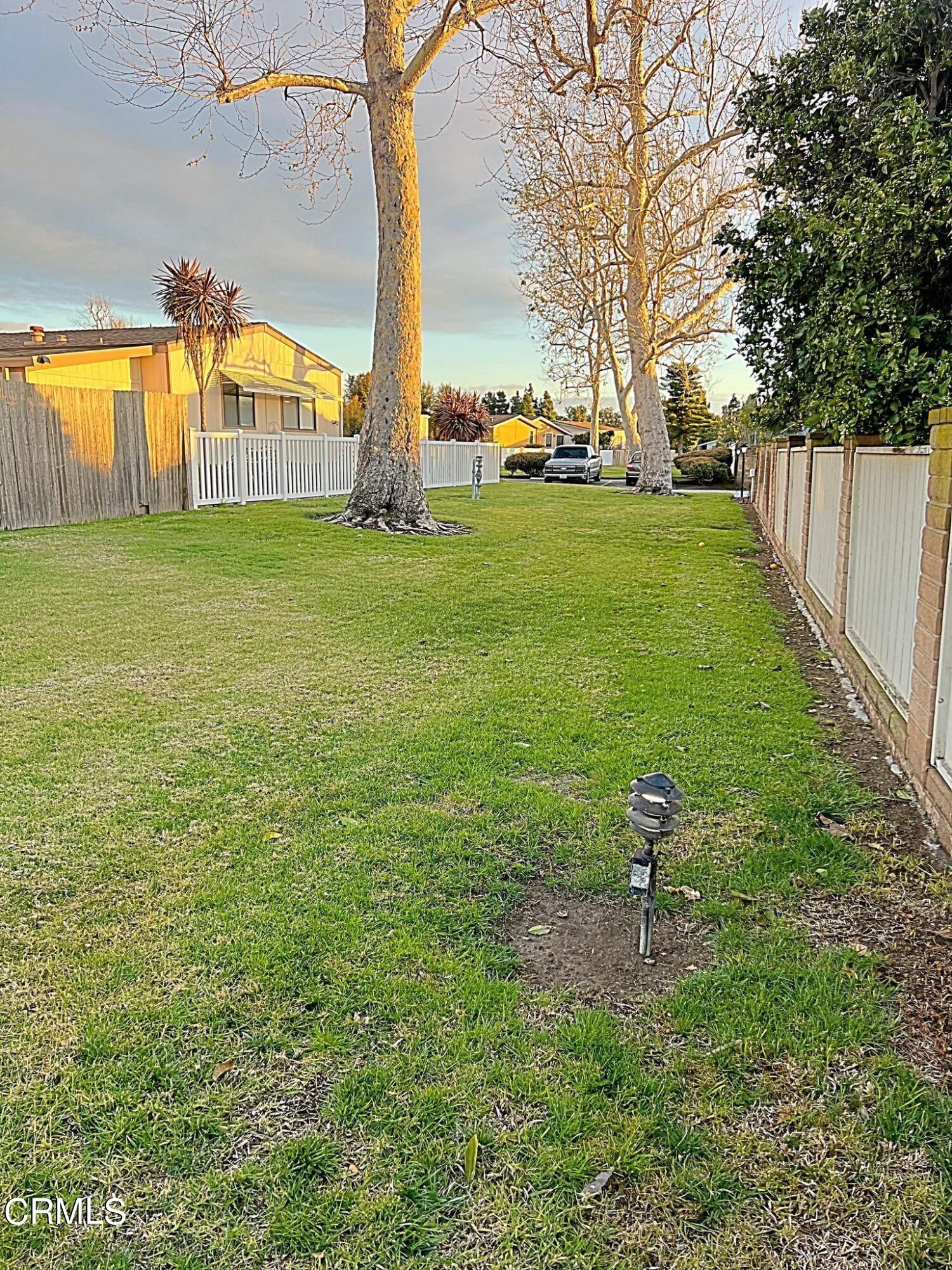 2510 Elderberry Drive, Unit 60 Oxnard, CA 93036 - Photo 30 of 37 a backyard of a house with table and chairs