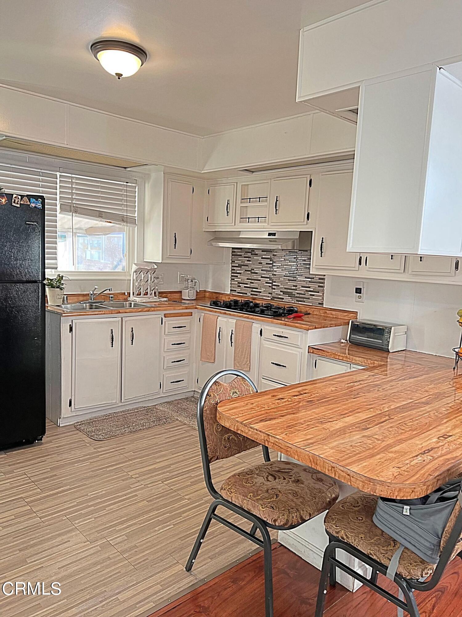 2510 Elderberry Drive, Unit 60 Oxnard, CA 93036 - Photo 5 of 37 a kitchen with granite countertop a stove a sink dishwasher and a refrigerator