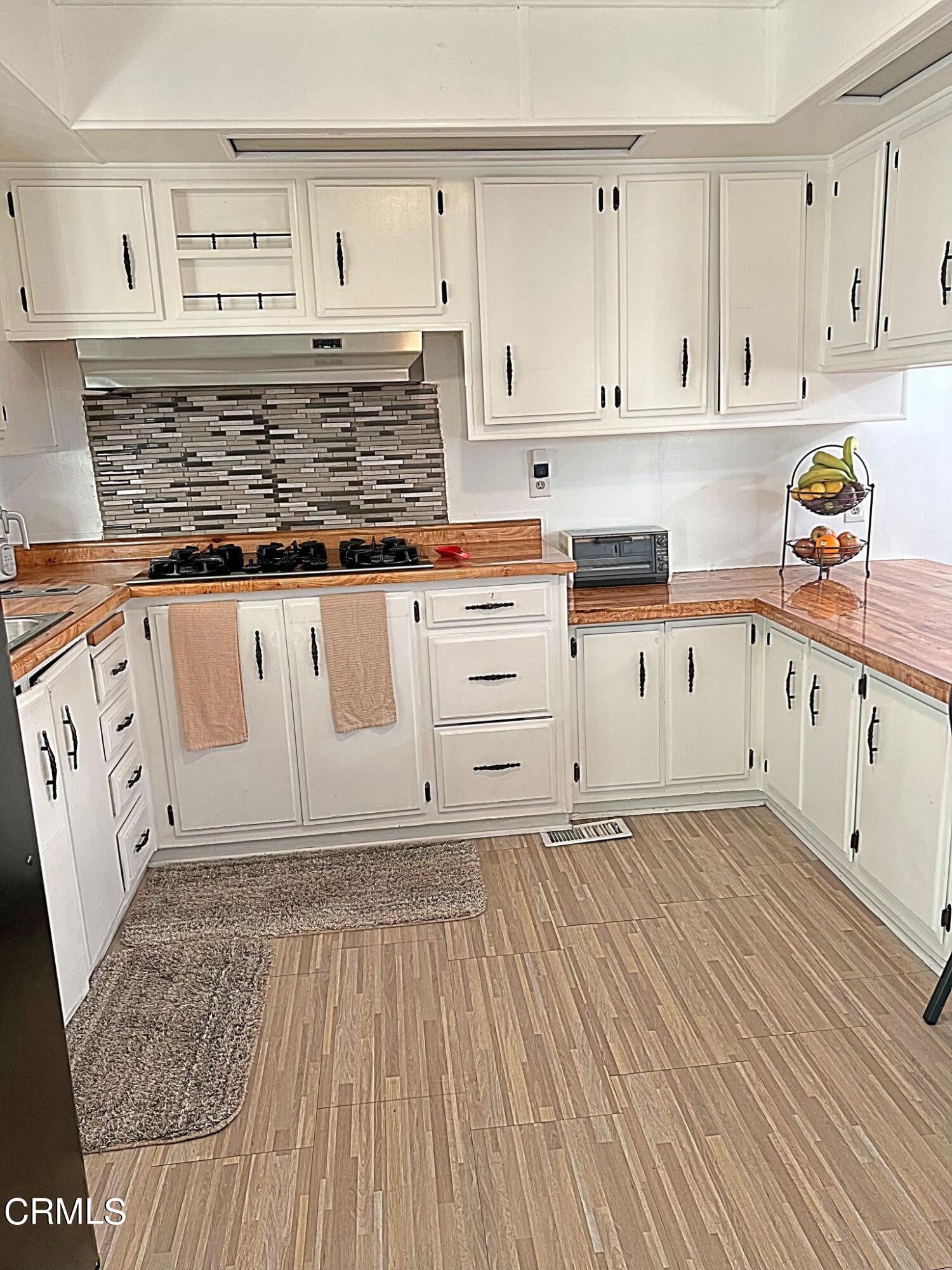 2510 Elderberry Drive, Unit 60 Oxnard, CA 93036 - Photo 8 of 37 a kitchen with granite countertop white cabinets and white appliances