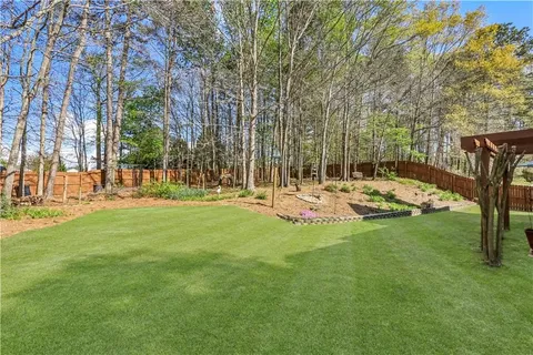 a view of a house with a yard and sitting area