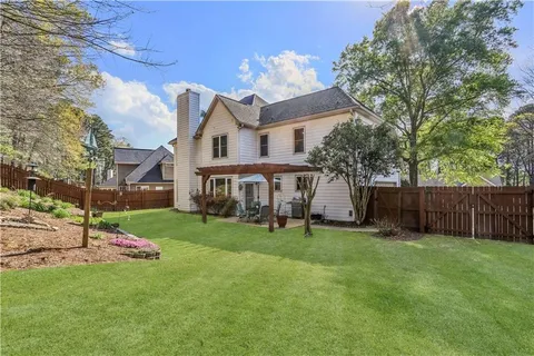 a front view of a house with a garden and yard