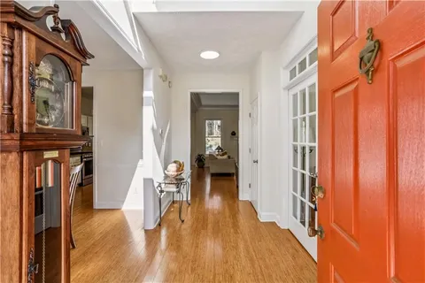a view of a hallway with wooden floor and staircase