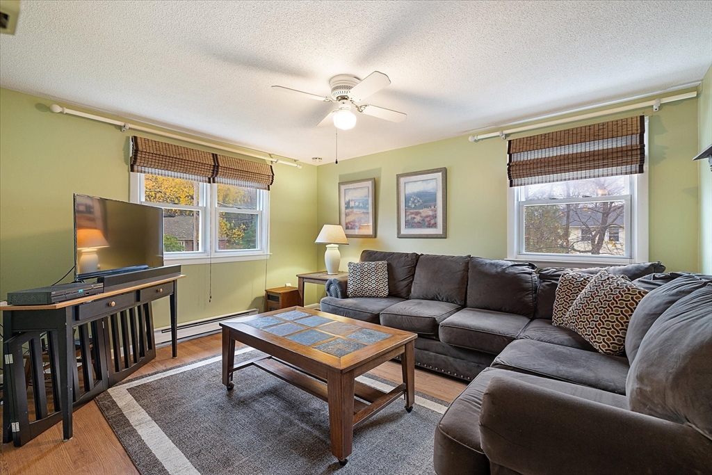 405 Cross Street Boylston, MA 01505 - Photo 18 of 34 a living room with furniture a flat screen tv and a window