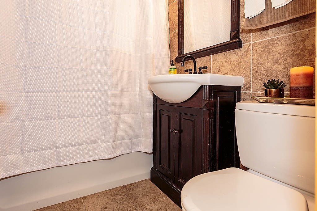 9 Arbor Road Chelmsford, MA 01863 - Photo 8 of 25 a bathroom with a sink a toilet and bathtub
