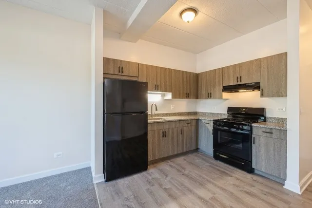 a kitchen with a refrigerator stove and sink