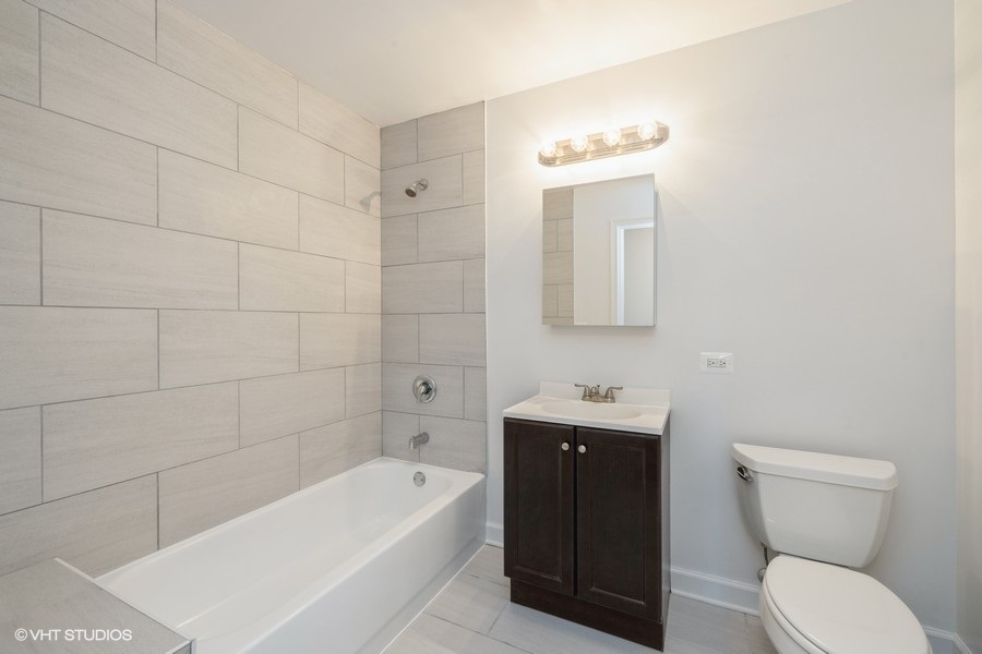 4752 South Wabash Avenue, Unit 102 Chicago, IL 60615 - Photo 5 of 9 a bathroom with a sink a toilet and bathtub