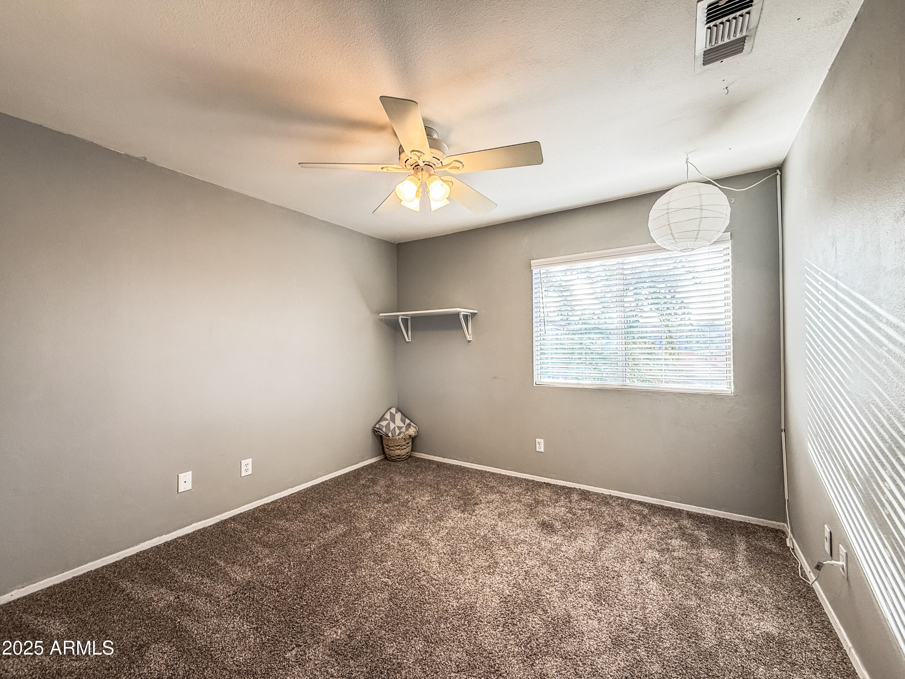 5057 East Delta Avenue Mesa, AZ 85206 - Photo 12 of 26 a view of an empty room with a window
