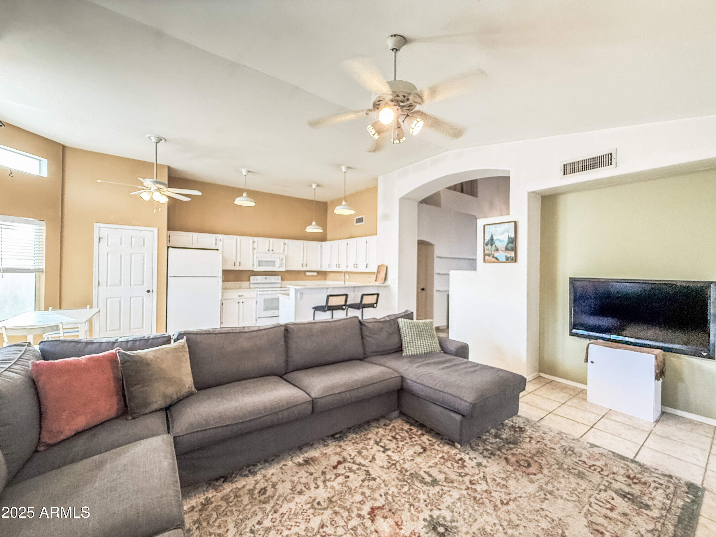 5057 East Delta Avenue Mesa, AZ 85206 - Photo 19 of 26 a living room with furniture and a flat screen tv