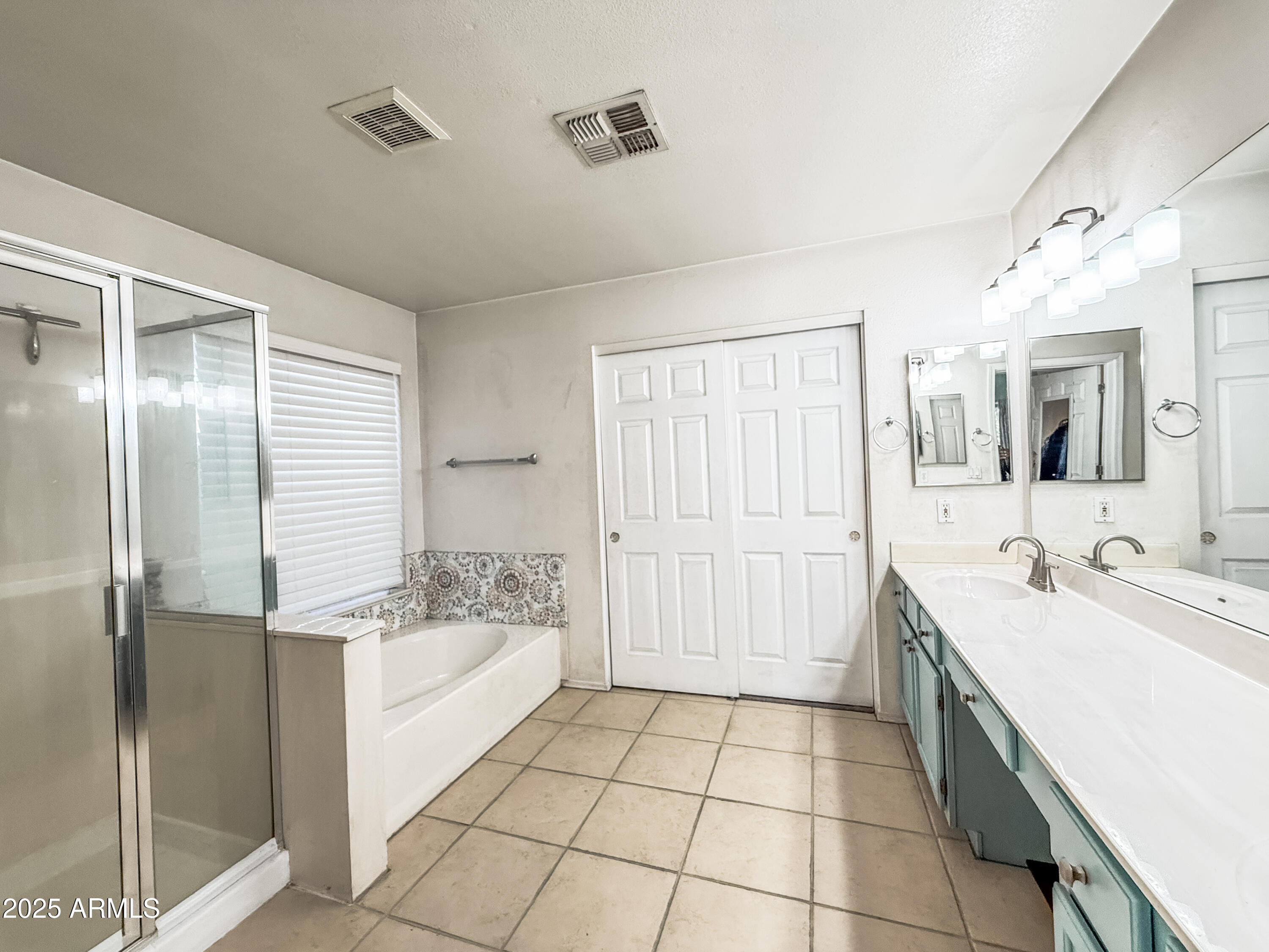 5057 East Delta Avenue Mesa, AZ 85206 - Photo 22 of 26 a spacious bathroom with a granite countertop sink a mirror and a bathtub