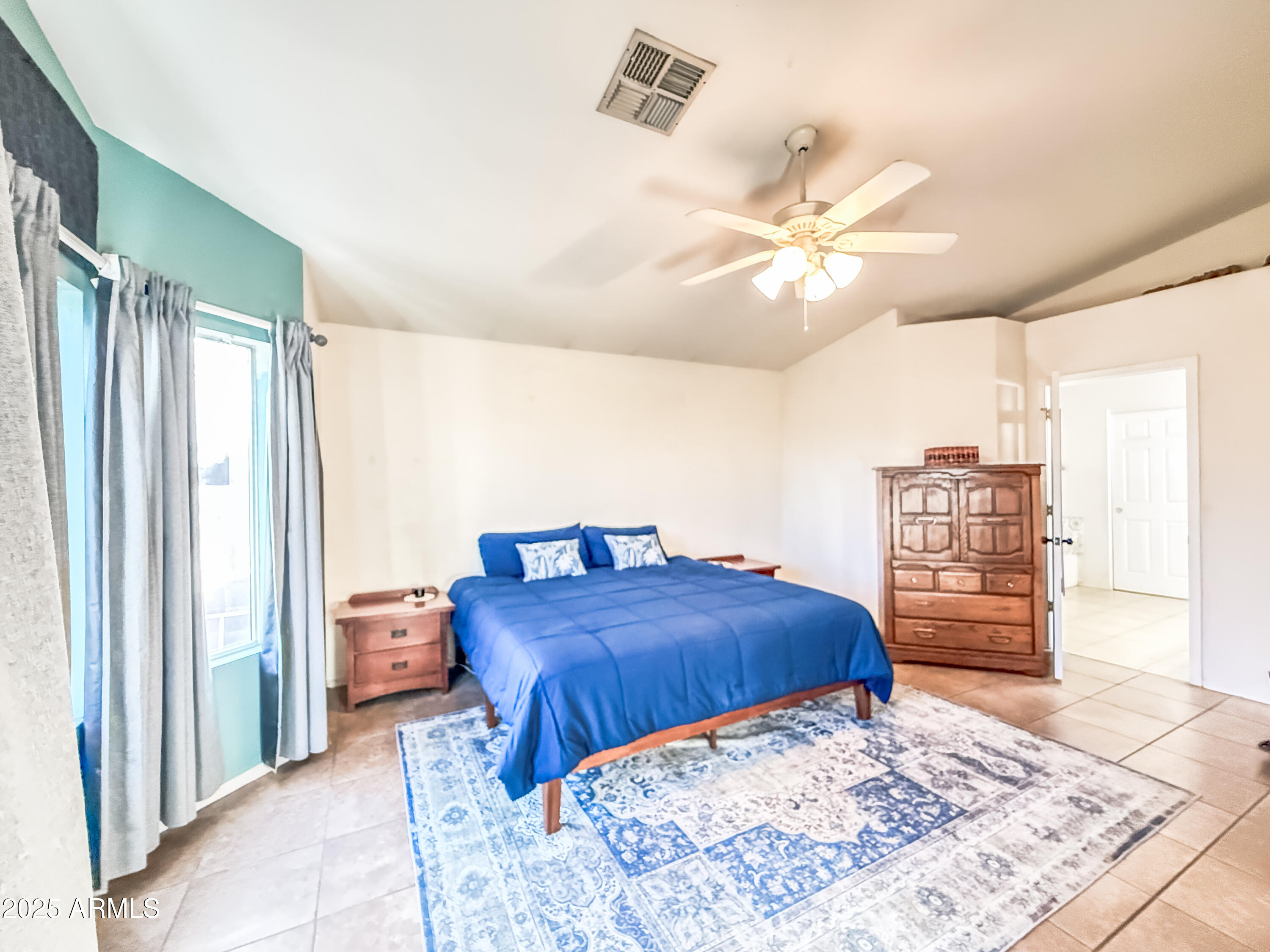 5057 East Delta Avenue Mesa, AZ 85206 - Photo 25 of 26 a bedroom with a large bed and a chandelier