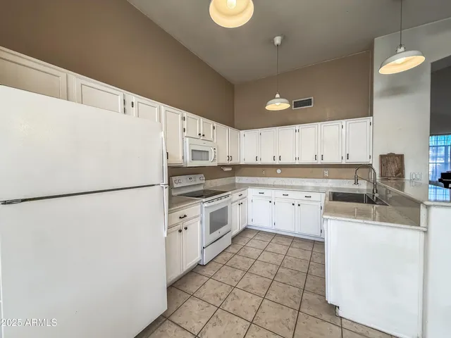 a kitchen with stainless steel appliances a refrigerator sink and cabinets