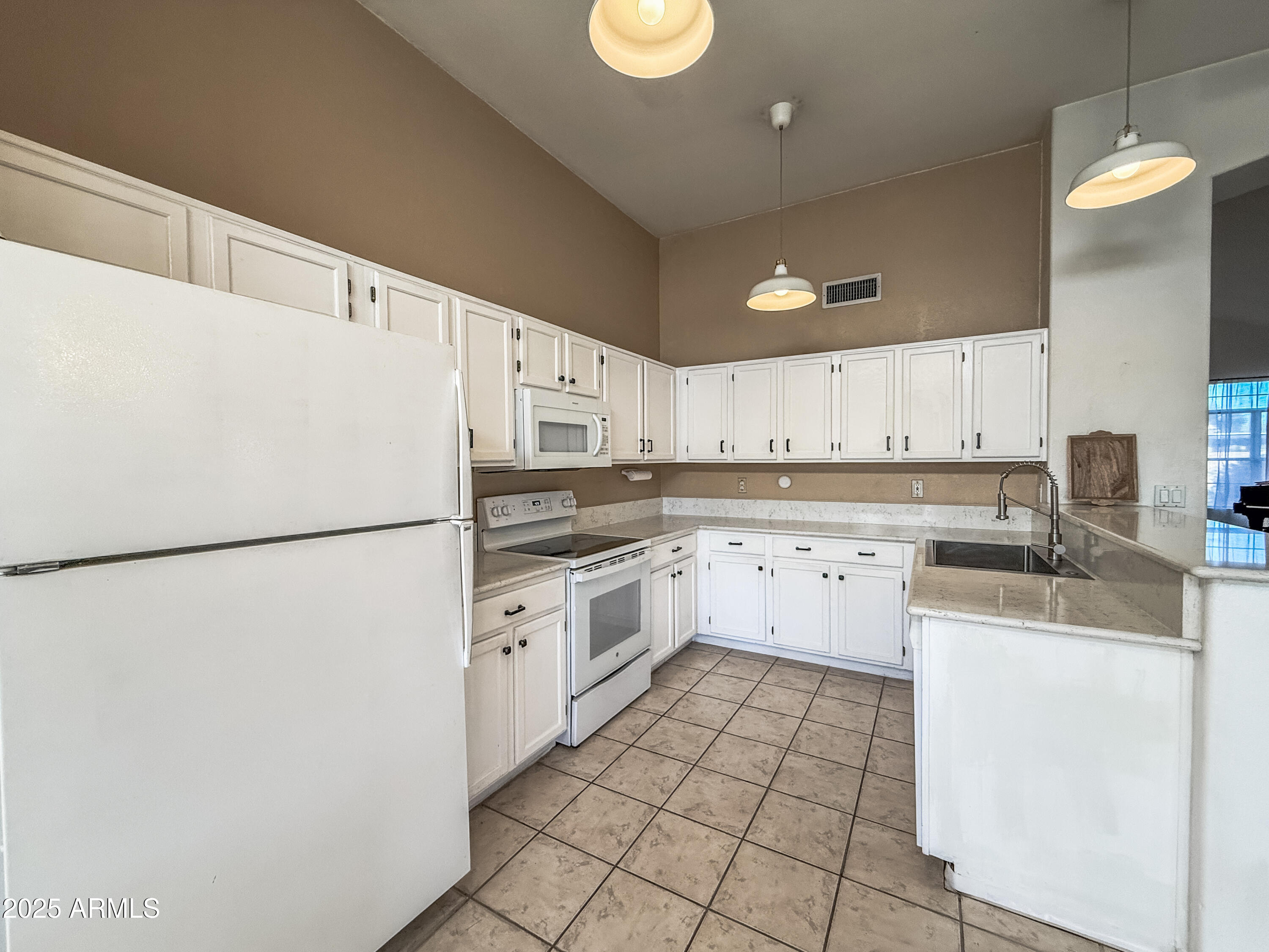 5057 East Delta Avenue Mesa, AZ 85206 - Photo 4 of 26 a kitchen with stainless steel appliances a refrigerator sink and cabinets