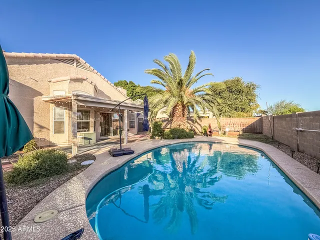 a view of a swimming pool with a patio