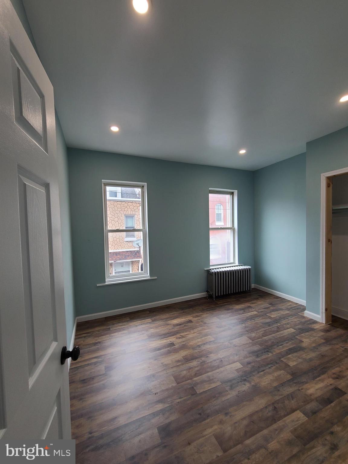 1218 Fidelity Street Reading, PA 19604 - Photo 8 of 14 an empty room with wooden floor and windows