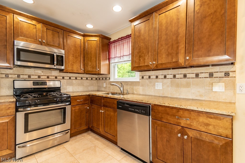 2219 Fenwick Road Cleveland, OH 44118 - Photo 9 of 32 All kitchen appliances stay. Nice neutral granite counter tops and tiled backsplash.