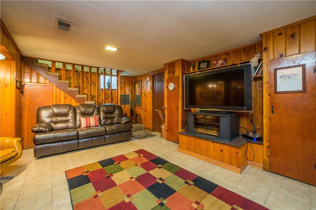 1313 McCully Road Pittsburgh, PA 15234 - Photo 15 of 25 The finished lower level gameroom offers fabulous bonus living space (285 sq ft). It has knotty-pine paneling, ceramic tile floor, and storage space galore.