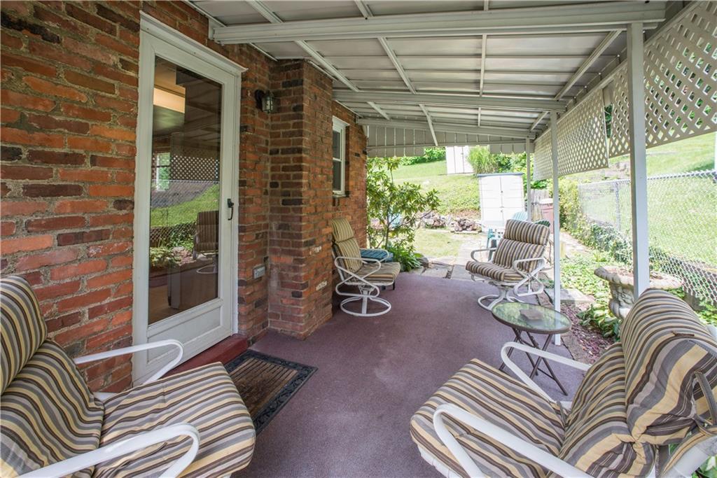 1313 McCully Road Pittsburgh, PA 15234 - Photo 20 of 25 Keep an eye on all of the backyard action from the shaded comfort the covered patio provides. The door on the left opens into the kitchen, simplifying outdoor dining and entertaining.