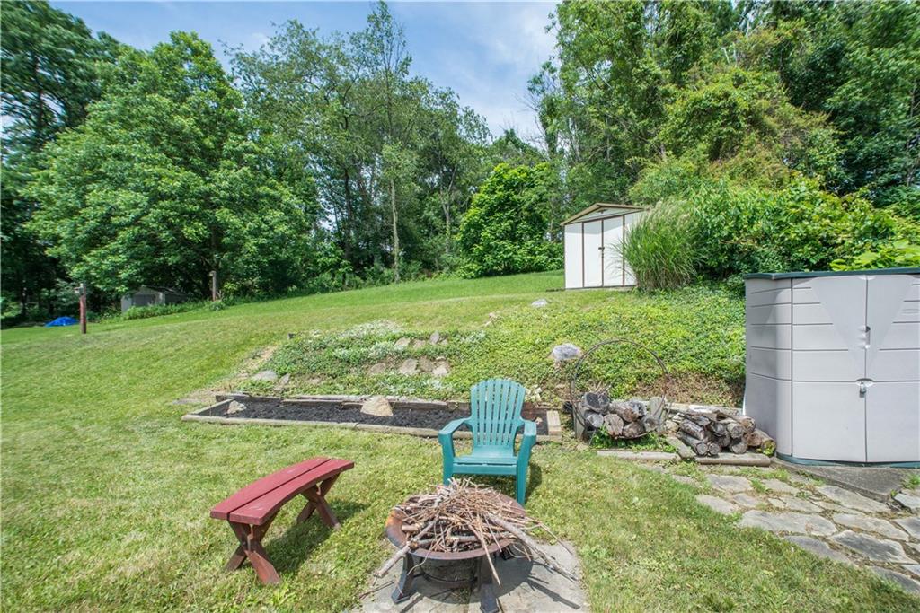 1313 McCully Road Pittsburgh, PA 15234 - Photo 22 of 25 The rear yard is slightly tiered and offers additional landscaping beds at the end of the stone path off the patio. Mature trees create a natural border between neighboring properties.