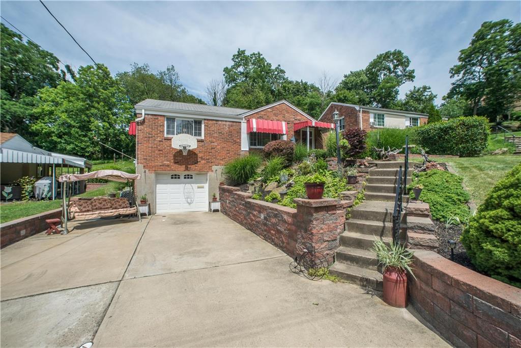 1313 McCully Road Pittsburgh, PA 15234 - Photo 25 of 25 Newer retaining walls border the concrete drive leading to the integral garage. The driveway was widened to provide bonus off-street parking for guests. A home warranty is also offered.