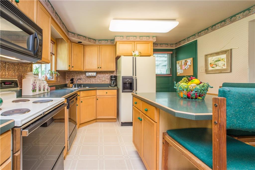 1313 McCully Road Pittsburgh, PA 15234 - Photo 6 of 25 The eat-in kitchen is fully equipped and has loads of work and storage space sure to please the home chef. Access to the lower level is also offered in the kitchen.