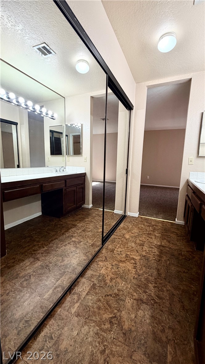 6250 West Flamingo Road, Unit 4 Las Vegas, NV 89103 - Photo 23 of 45 This primary bathroom features a double vanity and a spacious closet.