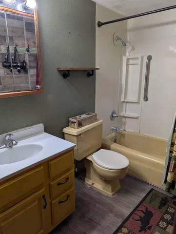 a bathroom with a sink toilet and shower