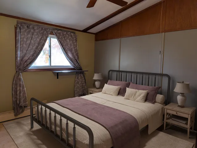 a bedroom with a bed and window